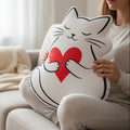 Cat Holding Heart Pillow — Soft Love, Slightly Judged
