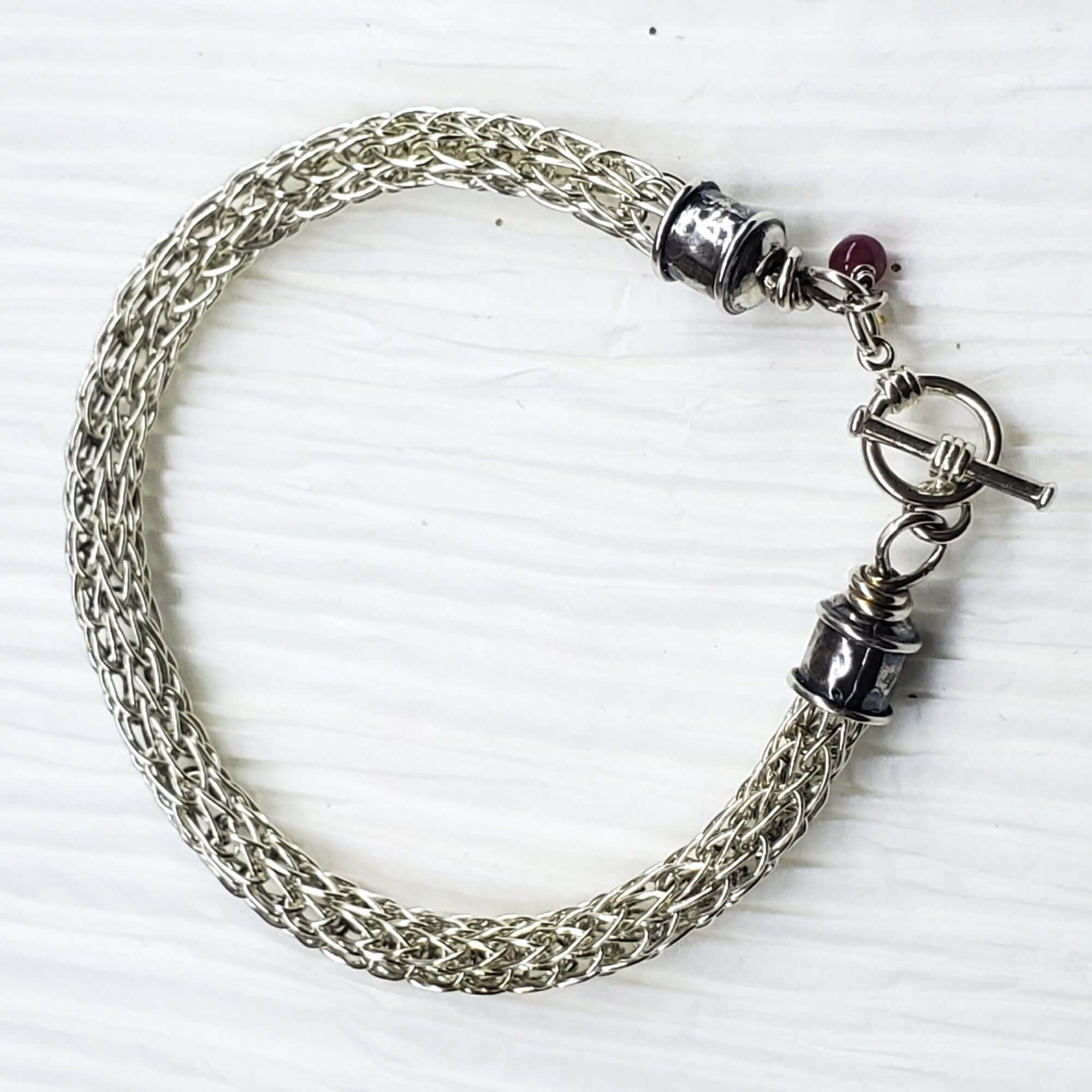 Handmade 10mm silver Viking knit bracelet with Ruby charm